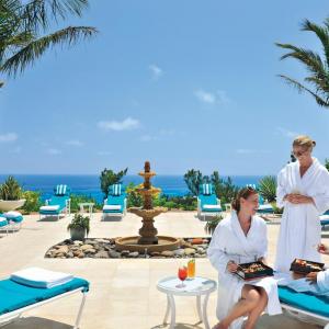 travelers relax by the pool at the fairmont in bermuda
